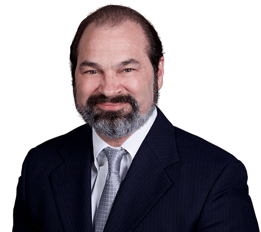 Man in suit smiling against grey background.