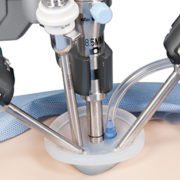 Robotic surgical arm performing minimally invasive procedure.